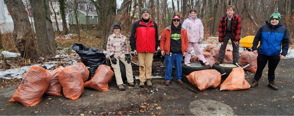 A group of people standing in front of garbage bags
AI-generated content may be incorrect.